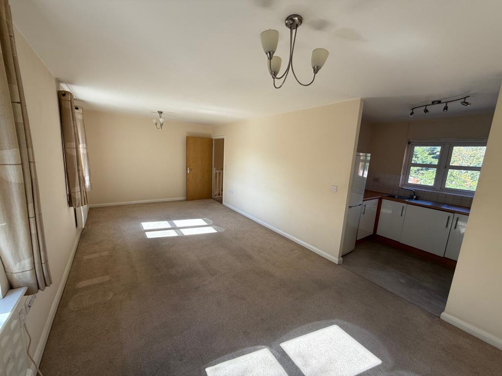 Lot: 136 - VACANT TWO-BEDROOM COACH HOUSE APARTMENT WITH GARAGE - Living room with opening to the kitchen area